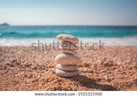 Stones on the beach against the sea. Beach background. Blue bakcground. Stones background. Beach made of stones. High quality photo