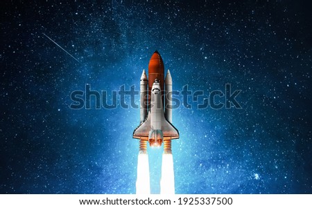 Spaceship in deep space. Starry sky and blue galactics. View on space shuttle and milky way. Elements of this image furnished by NASA Royalty-Free Stock Photo #1925337500