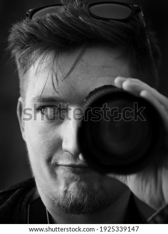 
The man looking into the lens