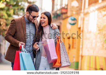 Portrait of happy couple with shopping bags.People,sale,consumerism and lifestyle concept. Royalty-Free Stock Photo #1925339198
