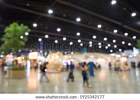 Abstract blur people in exhibition hall event trade show expo background. Large international exhibition, convention center, business marketing and event fair organizer concept. Royalty-Free Stock Photo #1925342177
