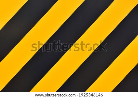 An illustration with alternating yellow and black diagonal lines. Construction site barricade concept.