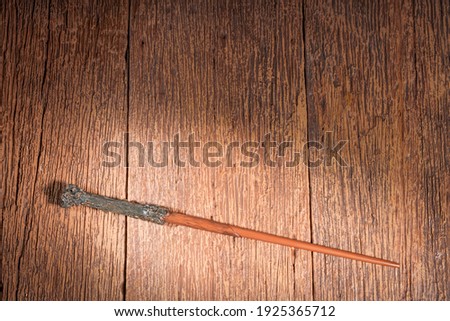 Magic wand on wooden table, Wizard tool. Wizards wand for fantasy story.