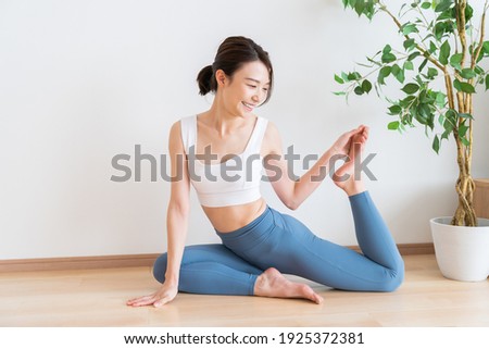Beautiful young asian woman exercising in the room