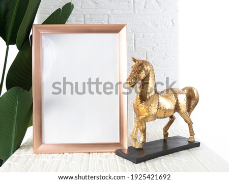Home interior poster mock up with square metal frame and gold horse on white wall background. 