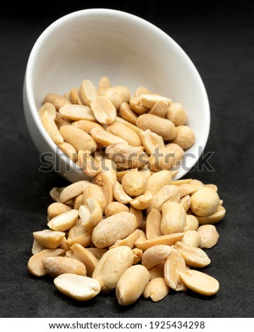 Unsalted peanuts in a withe bowl Royalty-Free Stock Photo #1925434298