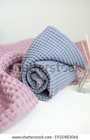 photography in pastel and bright colours. aromatherapy and spa at home, towels in lavender tones. aroma diffuser with chopsticks