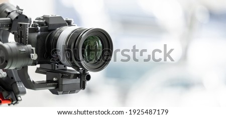 Gimbal video camera, Videographer using dslr camera anti shake tool for stabilizer record video. Royalty-Free Stock Photo #1925487179