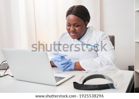 Skilful female doctor consulting patient while making online webcam video call on laptop. Multiracial woman videoconferencing in remote computer healthcare telemedicine virtual chat. Telehealth video