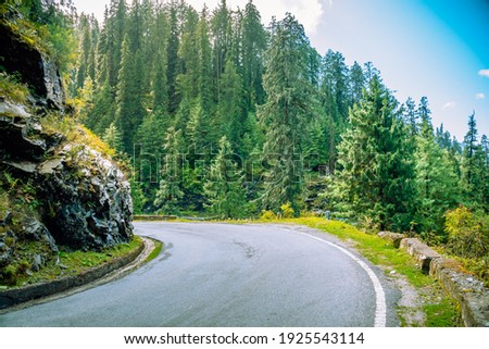 View of scenic highway in McLeod Ganj. McLeod Ganj is a suburb of Dharamshala in Kangra district of Himachal Pradesh, India. Royalty-Free Stock Photo #1925543114