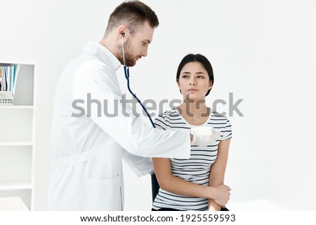 male doctor examines patient in hospital health