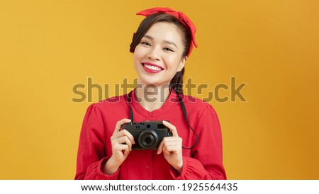 Portrait of young photographer woman using a professional digital camera