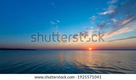 sunset over the Vistula Lagoon Royalty-Free Stock Photo #1925571041