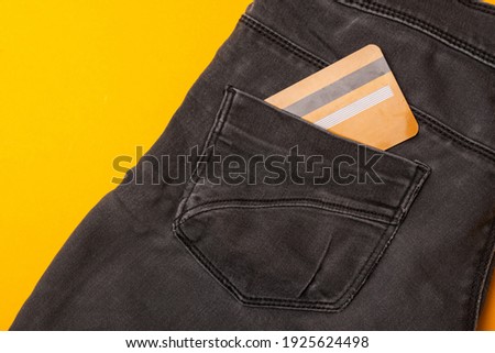 Close up photo of black jeans with credit card in pocket