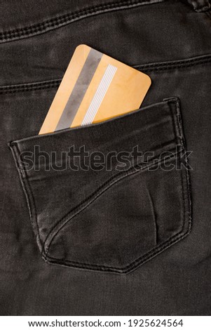 Close up photo of black jeans with credit card in pocket