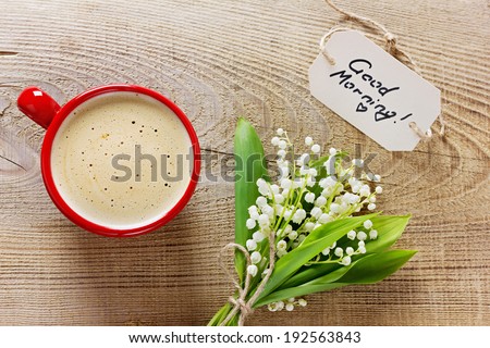 Coffee cup with flowers and notes on a wooden rustic background