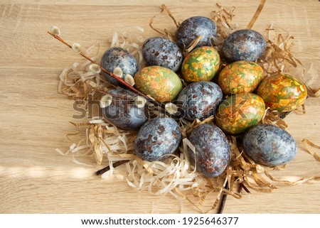 Beautiful Easter composition - colored eggs, similar to marble, ears of wheat, willow branches, traditionally, handmade
