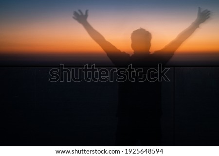 silhouette image of a photographer with sunset background