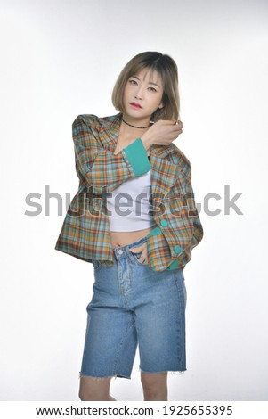 Beautiful Korean woman in casual jacket and blue shorts