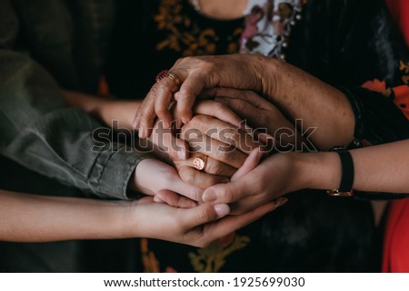 three generations of hands together Royalty-Free Stock Photo #1925699030