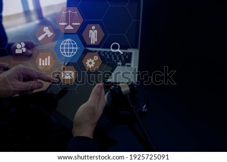 Legal advice concept. Lawyer working on tablet office and law virtual interface screen, Blurred background.