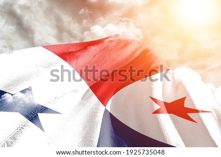 Panama national flag cloth fabric waving on beautiful grey sky.