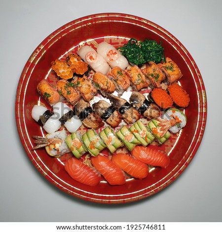 Mixed sushi roll and sashimi platter. Soft focus image.