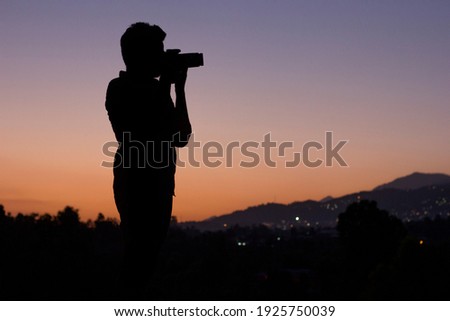 Young boy with camera taking photos
