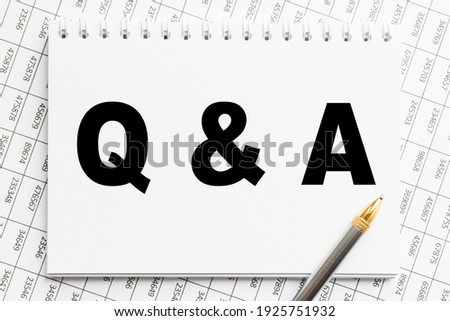 Notepad with inscriptions Q AND A on a white background. business concept.
