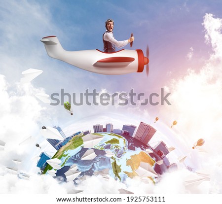 Man in aviator hat with goggles driving propeller plane. Earth globe with high modern buildings. Funny man having fun in small airplane. Blue cloudy sky with flying hot air balloons and paper planes Royalty-Free Stock Photo #1925753111