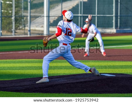 Action photo of high school baseball players making plays during a baseball game