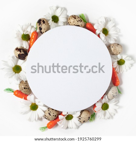 Easter round frame made of flowers, carrots and eggs. creative concept. copy space