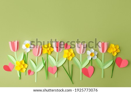 Happy Easter paper craft for kids. Paper DIY seasonal flowers tulips and hearts on pastel green background. Spring decor, create art for children, daycare, kindergarten, flyer greeting card Royalty-Free Stock Photo #1925773076