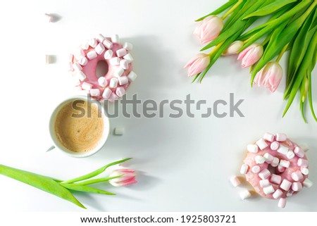 Cup of cappuccino with pink donut and marshmallow, tulip flowers on a white background, top view, isolated, number 8 with food