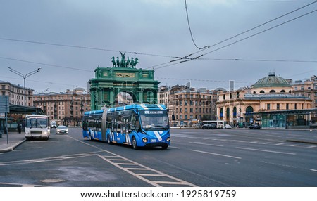 A modern trolleybus on Stachek Square at the Narva Triumphal Gate, Saint Petersburg.  Royalty-Free Stock Photo #1925819759