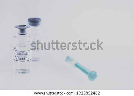 Coronavirus vaccine and syringe injection on light background. Medicine infectious concept. Prevention, immunization and treatment, fighting with covid -19 pandemic.