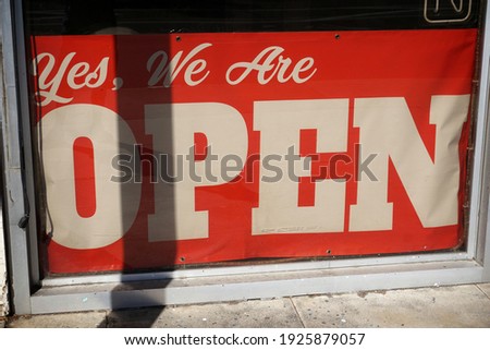 Aged and worn vintage yes we are open sign in window                               