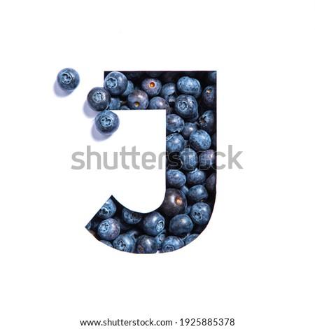 Letter J of English alphabet made of blueberries and paper cut isolated on white. Bilberry typeface
