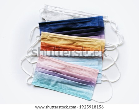 Top view photo of the multi-colored disposable face masks with double layers for wearing to protect against viruses and the others when out in public, new normal.