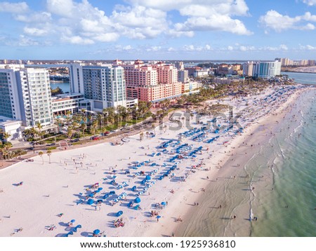 Ocean beach. Spring break or Summer vacations in Florida. Hotels, restaurants and Resorts in US. Blue-turquoise color water. American Coast or shore Gulf of Mexico. Clearwater Beach FL. Aerial view