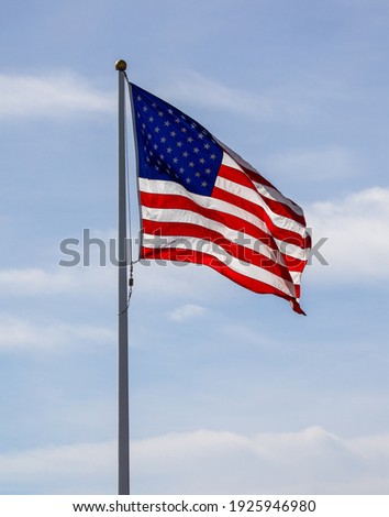 The American flag on the blue sky. 