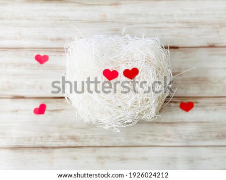 Two heart shaped papers on white paper packing