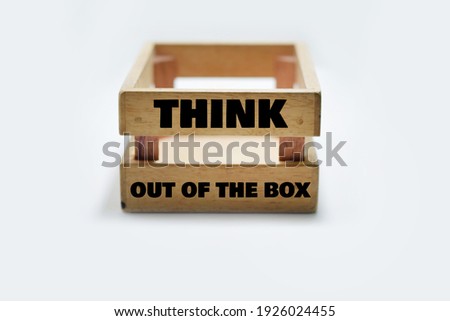 THINK OUT OF THE BOX Wording on A Wooden Box Isolated with White Background. Selective Focus