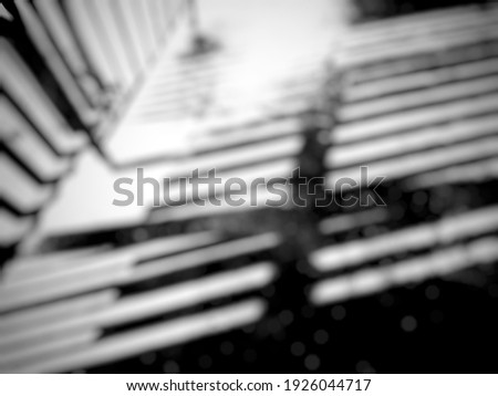 Defocused abstract background blurry black and white  picture of a fence shadow reflected on the floor with . 