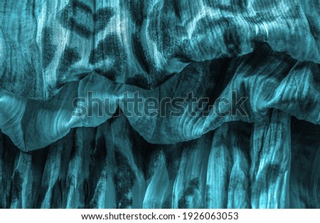 Blue fabric. Silk fabric in fine organza with panther print, Crumpled texture. Background. Template.