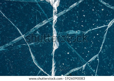 Shot of frozen waters full of cracks of baikal lake ice. Texture.