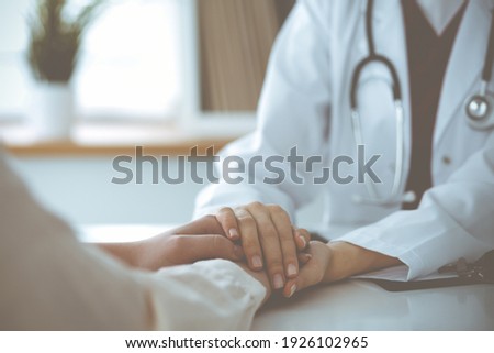 Hands of unknown woman-doctor reassuring her female patient, close-up. Medicine concept Royalty-Free Stock Photo #1926102965