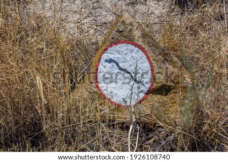 Beware of snakes sign in Gobustan petroglyph reserve, Azerbaijan