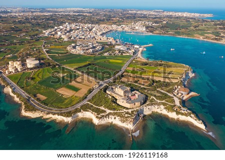 Aerial view of Maltese countryside. Tower and Marsaxlokk village.