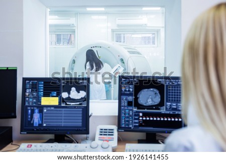 Radiologist in the control room of computed tomography at hospital Royalty-Free Stock Photo #1926141455